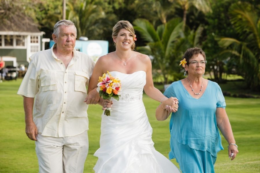 bride walking down the isle with parents