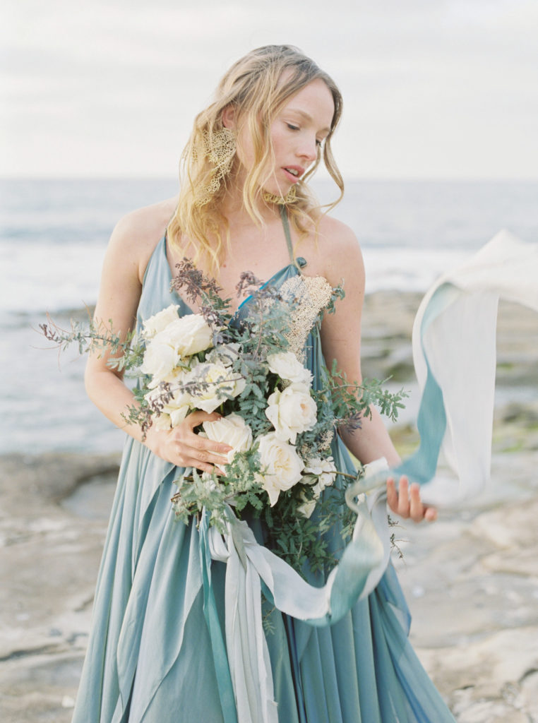 Bride on beach san diego california in blue wedding gown