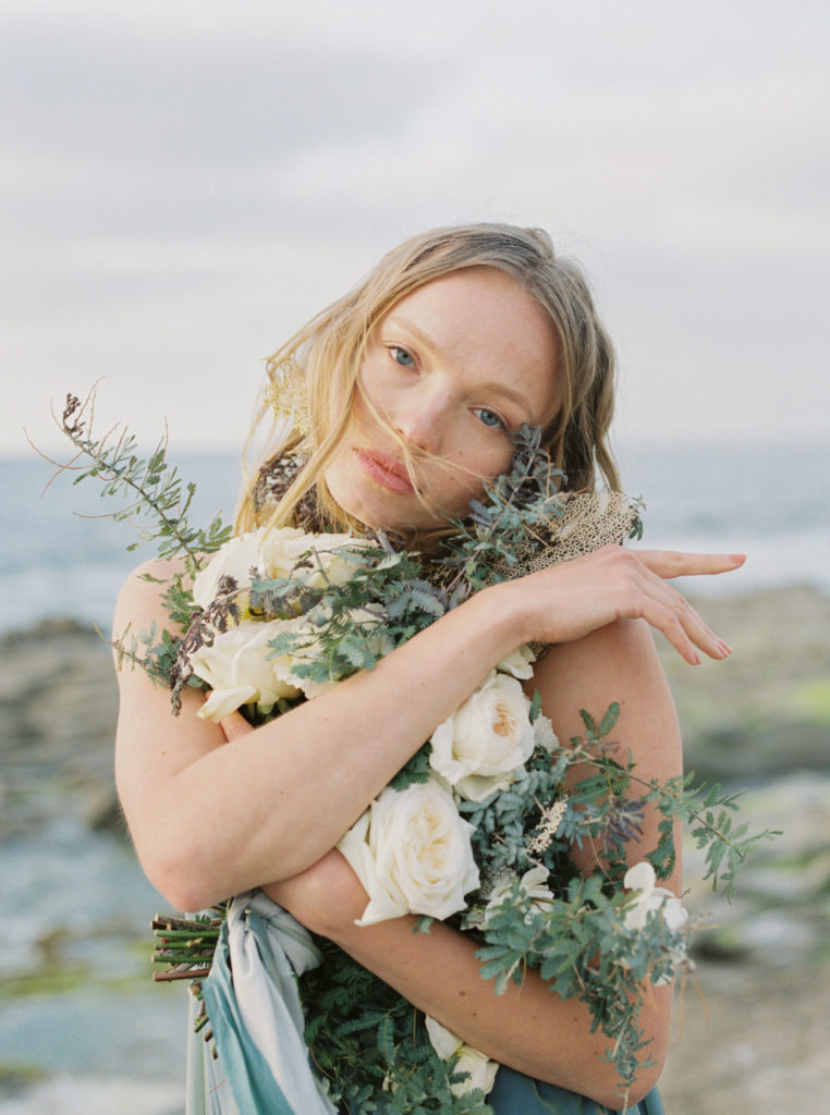 bride on the beach in San Diego California with bouquet