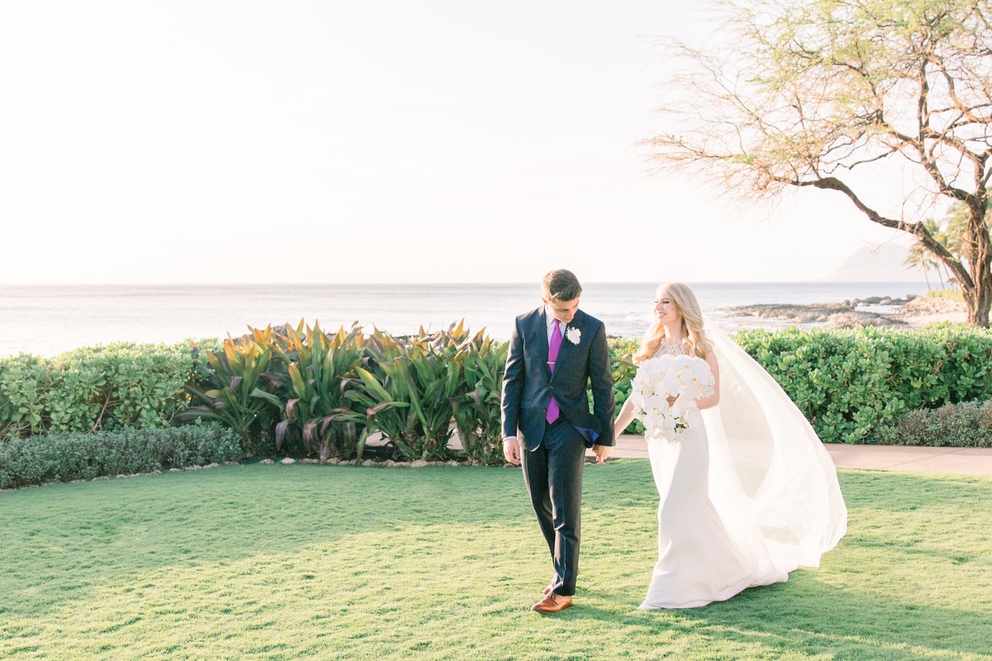 Modern Romantic Four Seasons Oahu Wedding 1 bride and groom walking on the ocean lawn Four Seasons Oahu