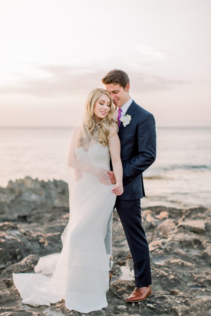 Modern Romantic Four Seasons Oahu Wedding 15 Couple in embrace on the beach at Four Seasons Oahu Wedding