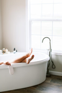 woman in bathtub relaxing, self care routine