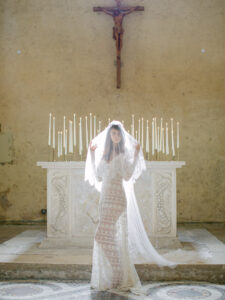 Bride with veil in candle lit church Italy, Tuscany