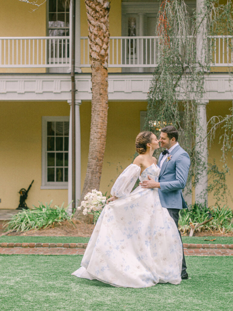 Bride wearing Anne Barge Wedding Gown in Charleston, SC, Bride and groom in embrace in front of William Aiken House, wedding day portraits, Bride and groom portrait, charleston wedding, charleston destination wedding, William Aiken House wedding