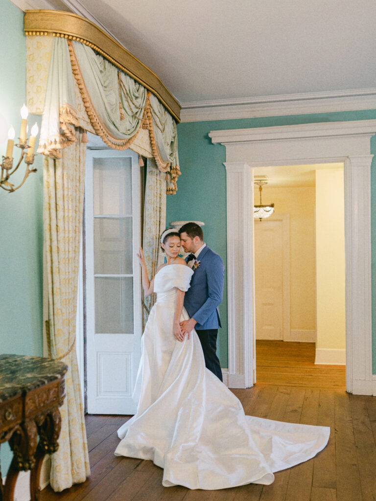 William Aiken House wedding, Bride wearing Delana Muse Wedding Gown, Bride and groom in embrace in front of the french doors at  at the William Aiken House, Bride and groom portrait, charleston wedding, charleston destination wedding