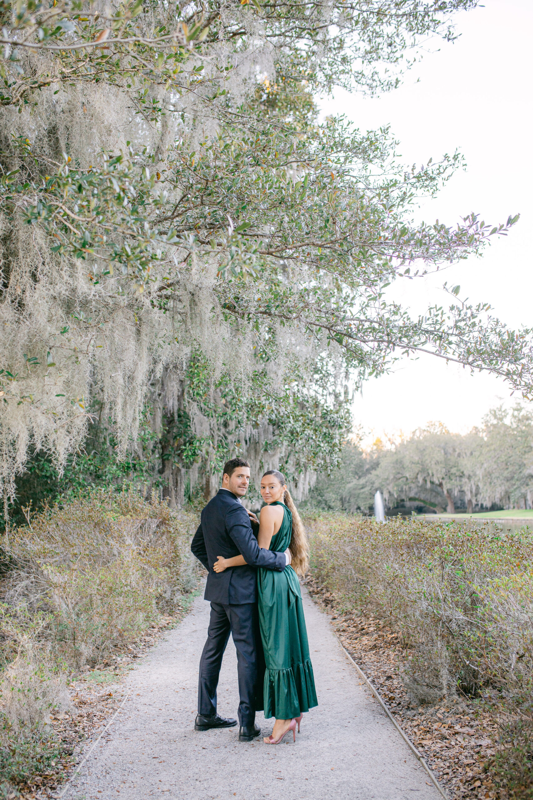 couple in love at middleton place engagement session, green gown, blue suit, what to wear for engagement session