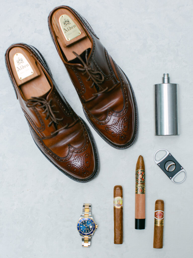still life of man details for a wedding. Ralph Lauren Brown Leather shoes, Blue faced Rolex watch and cigars