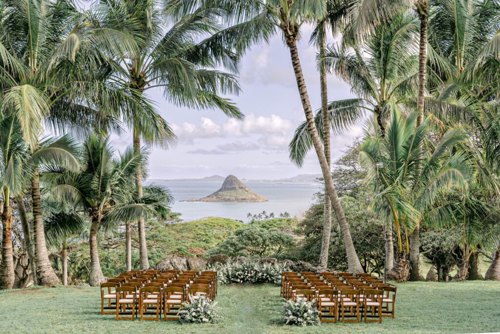 Kualoa Ranch Ceremony set up with palm trees and the pacific ocean in the background