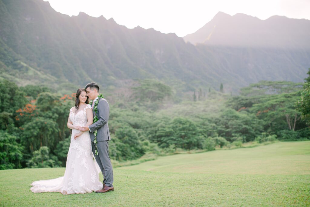 Bride and Groom embracing with the koolau mountains in background at Koolau Ballrooms