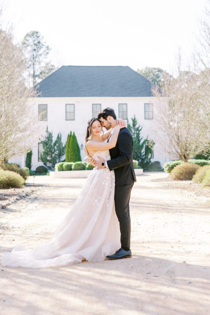 A Romantic Spring Wedding at The Bradford Estate in Raleigh, NC 1 couple embracing in front of Bradford Estate North Carolina Wedding Venue