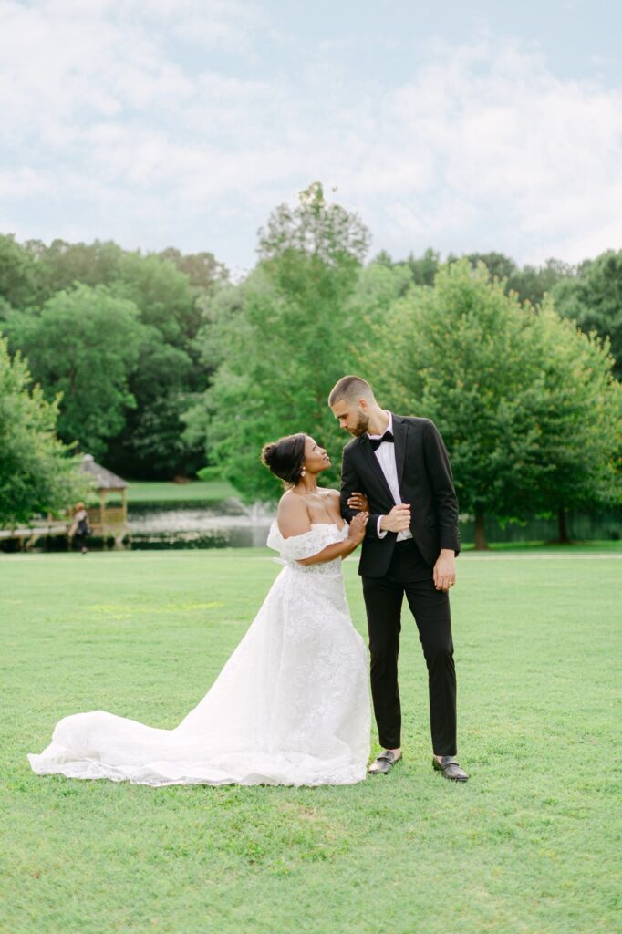 A Joyful Summer Wedding at a Private Estate in Raleigh, NC 14 Bride and Groom looking at each other lovingly at an outdoor wedding venue in raleigh nc