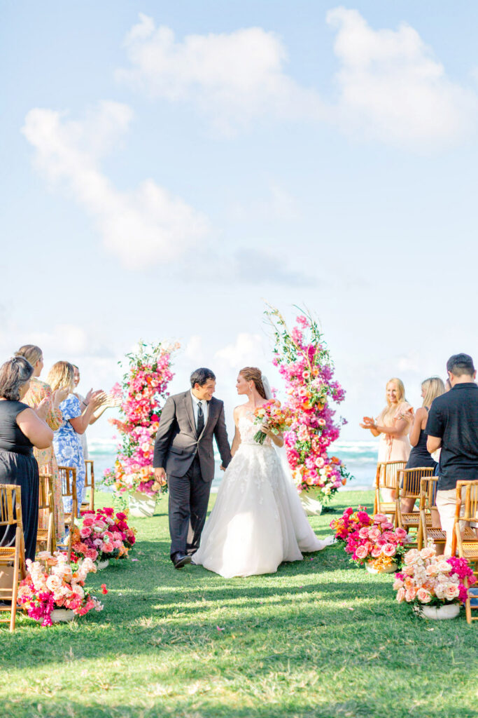Wedding ceremony with colorful floral arch, hawaii wedding florist designs by hemingway