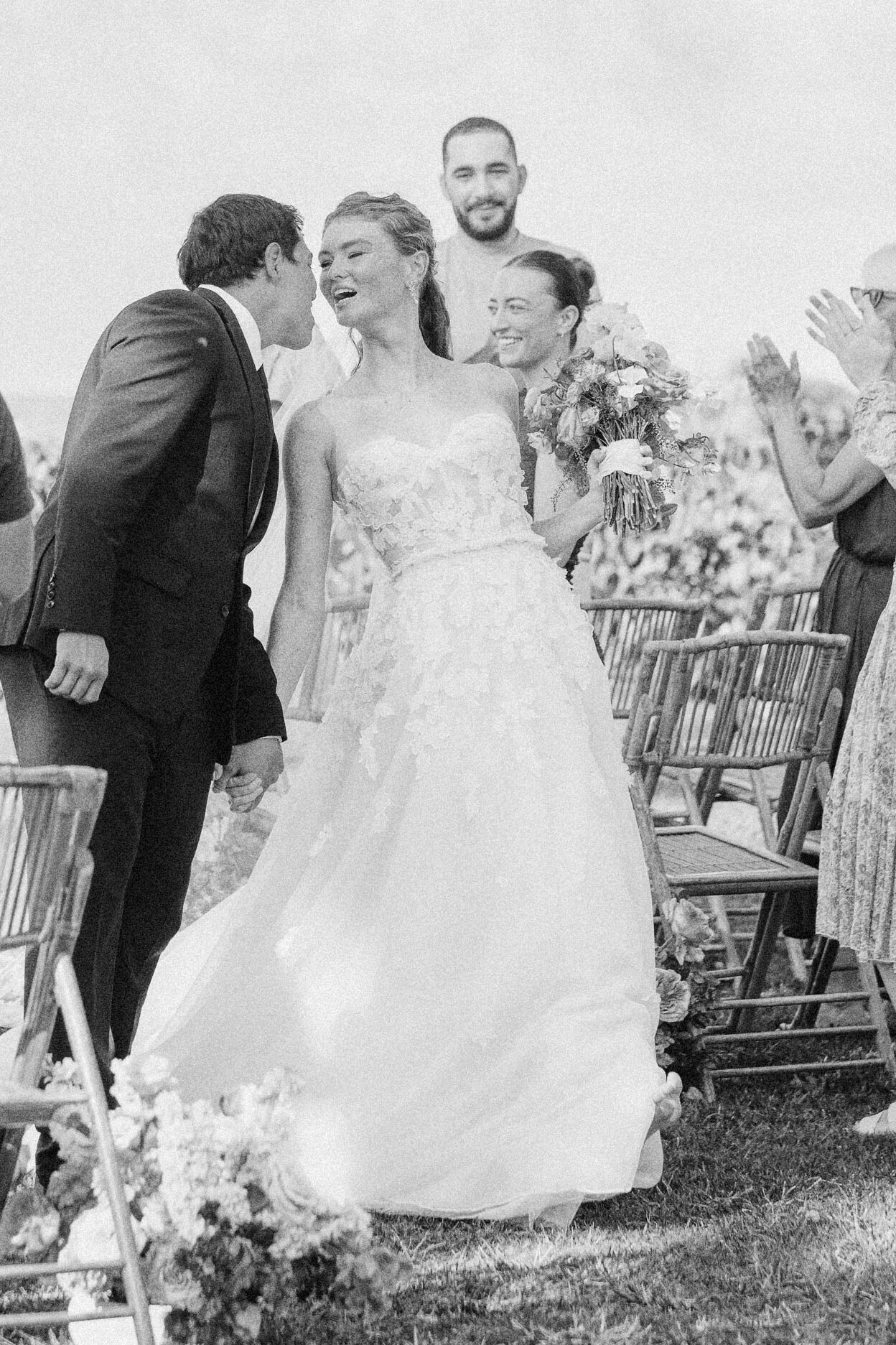 Wedding couple sharing a kiss walking sown the aisle loulu palm estate oahu