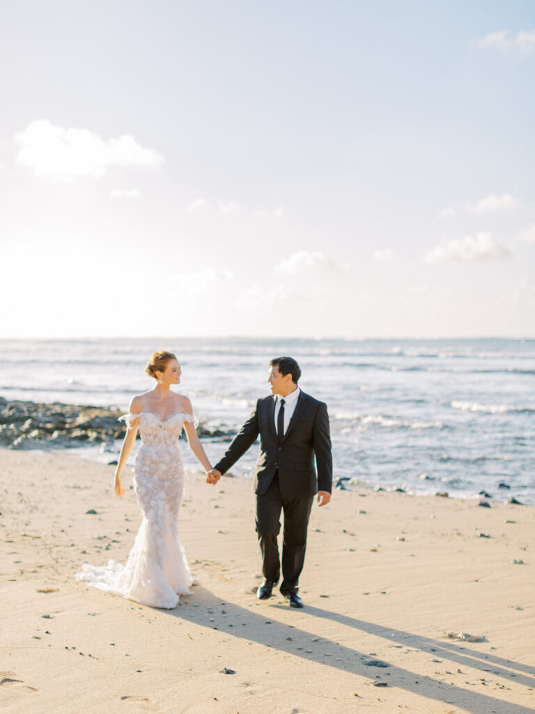 bride and groom walking on the beach in Hawaii